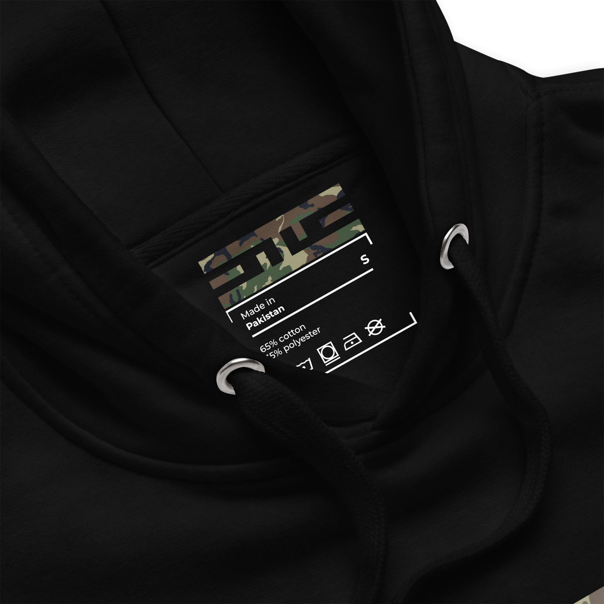 Close-up of the woodland camo ELITE® icon label printed inside the neck of the black hoodie